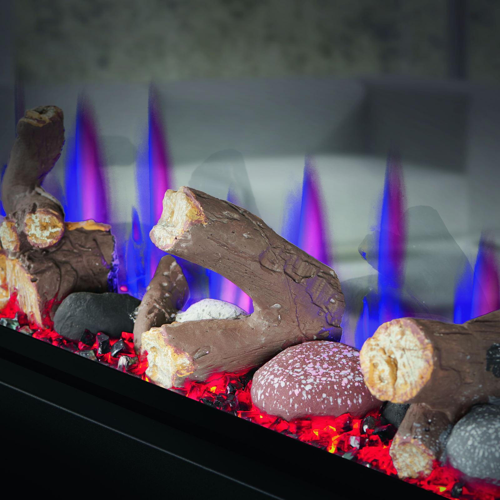 Decorative fireplace with glowing red and blue flames and decorative logs.