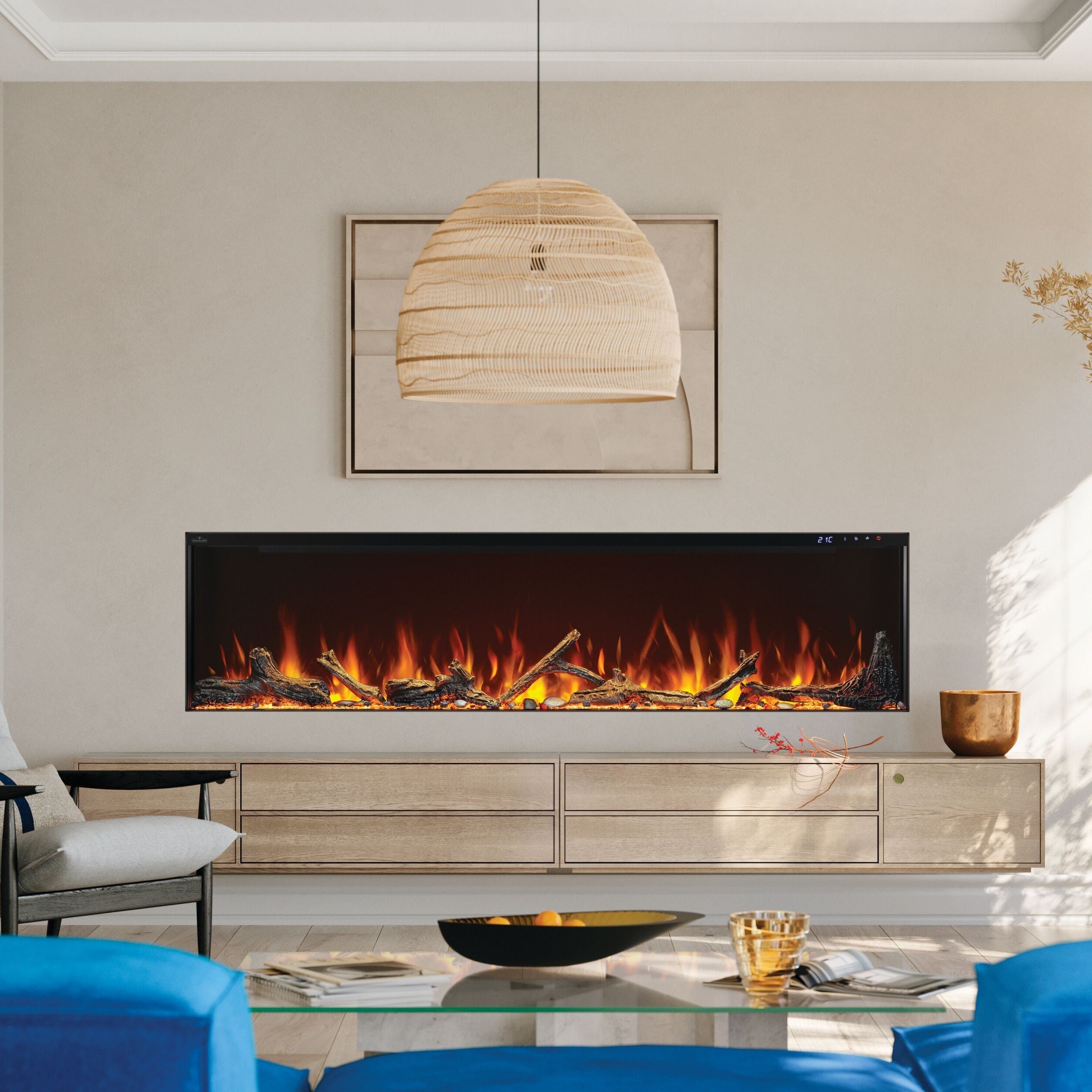 Modern living room with a fireplace, blue sofa, and decorative elements.