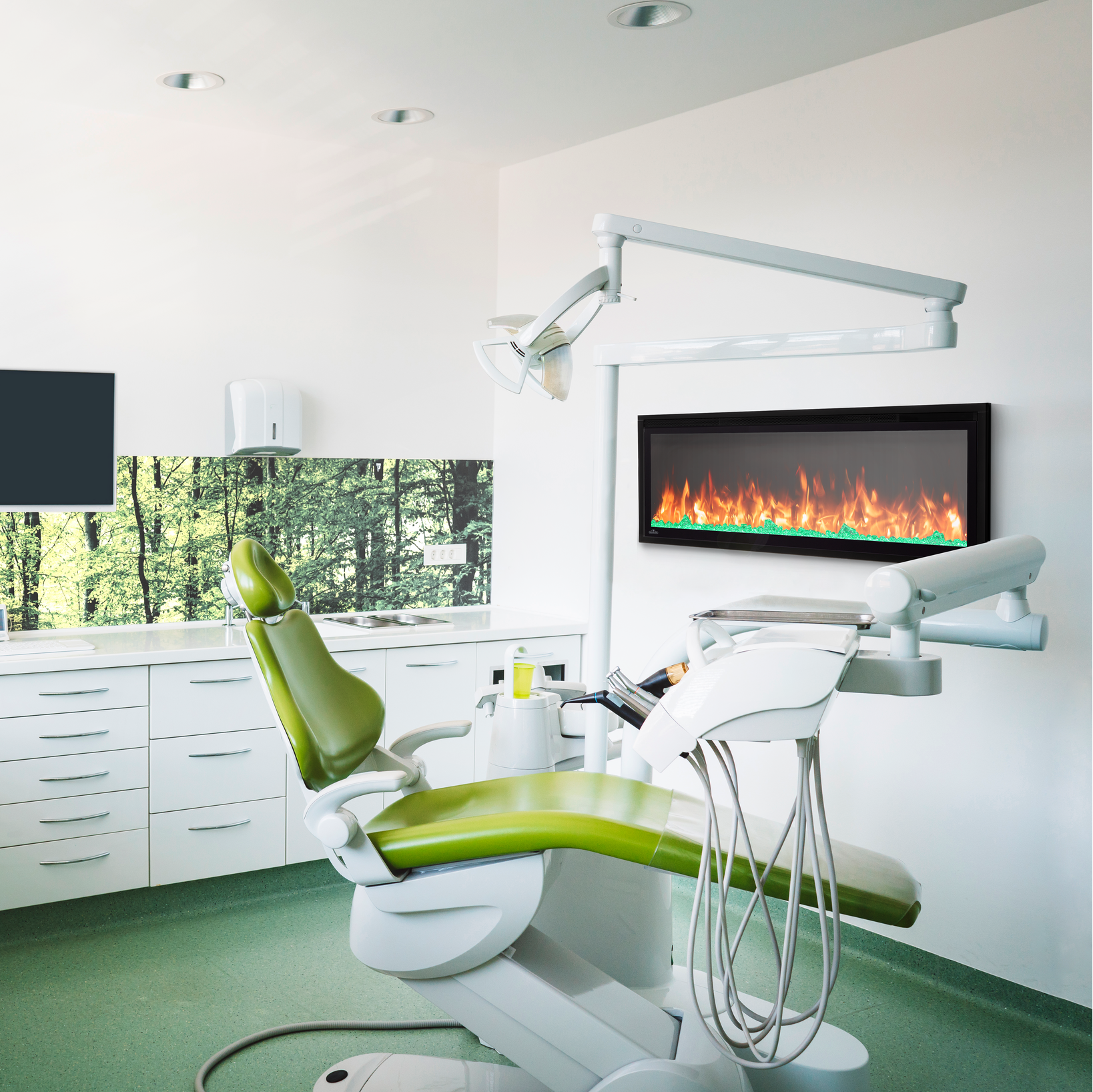 Modern dental office with green dental chair and white cabinets.