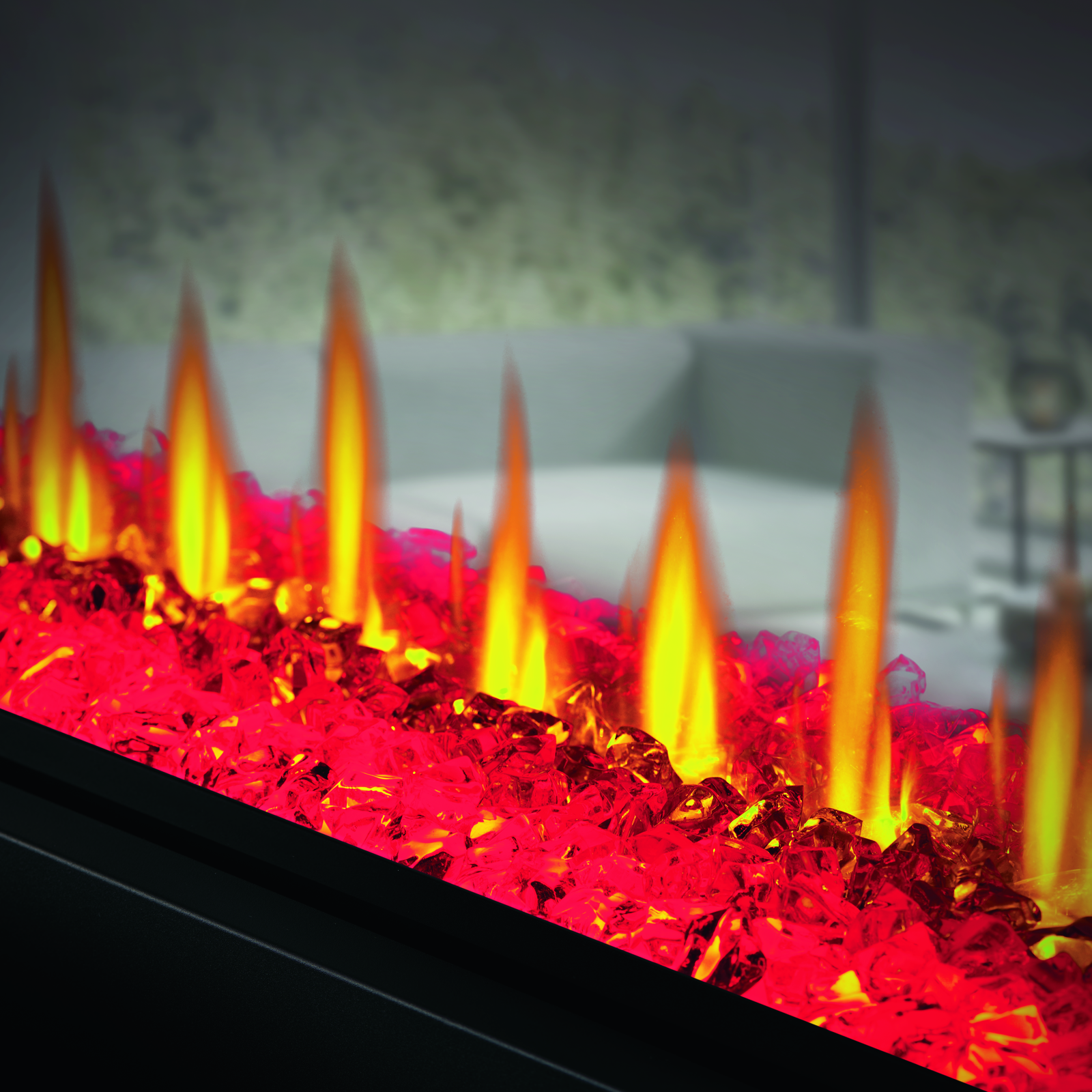 Close-up of a fire pit with glowing red and orange flames.