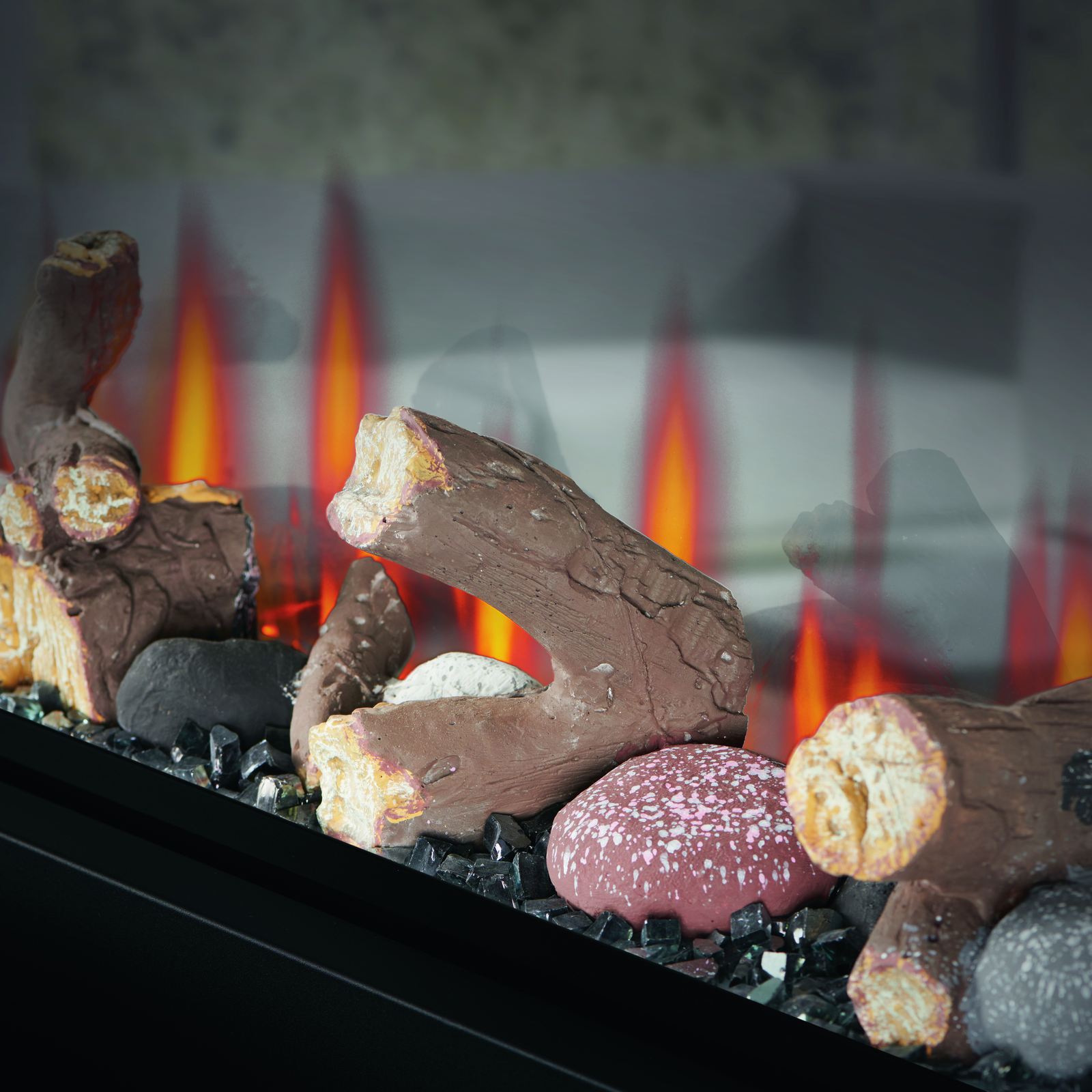 Decorative fireplace logs with a glowing fire in the background