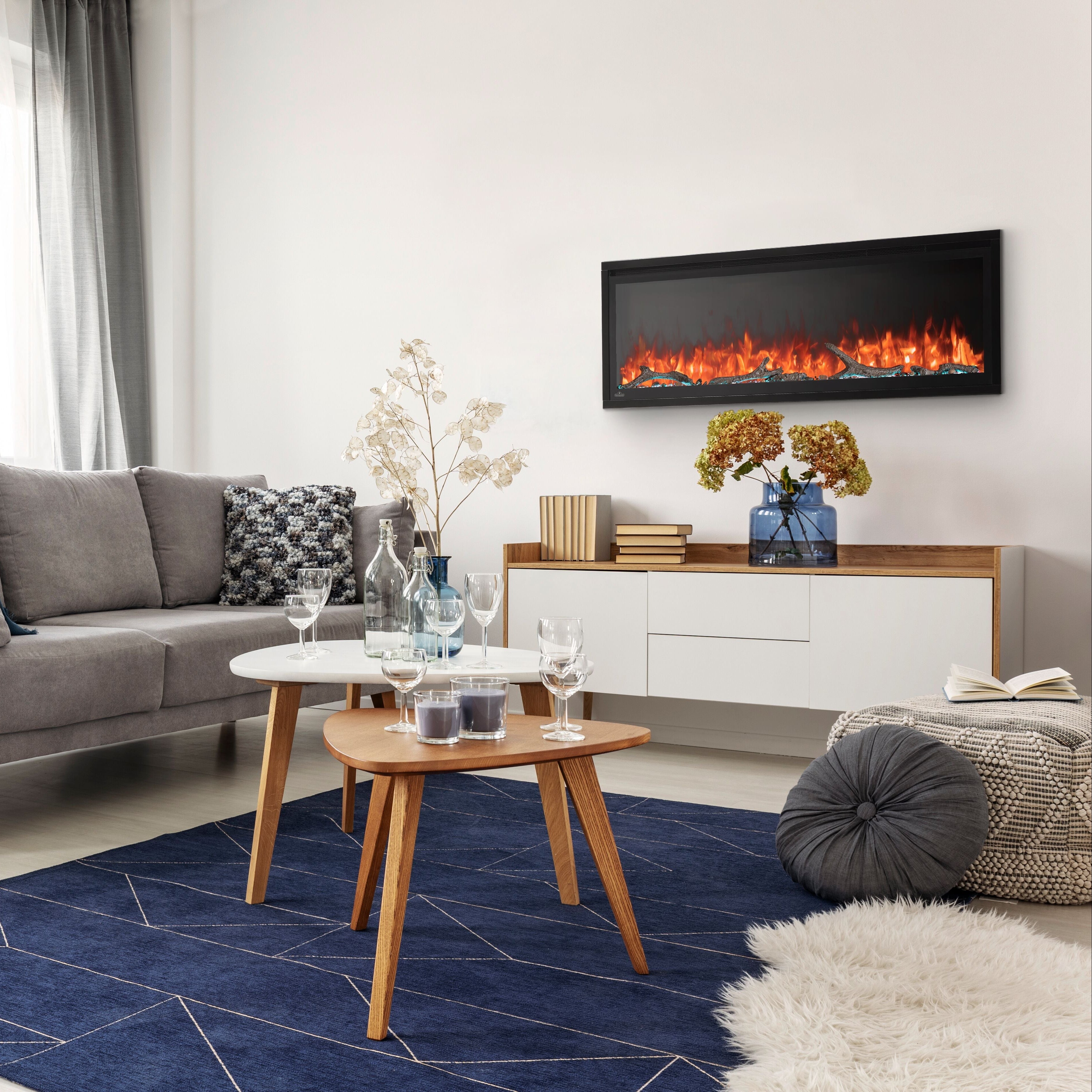 Modern living room with gray sofa, coffee table, and TV displaying a fire scene.